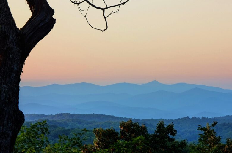 Breathtaking sunset view of the Blue Ridge Mountains, featured in the Brevard, NC travel guide showcasing the best things to do in Brevard, NC, including top hiking trails and the best waterfalls in Brevard, NC.